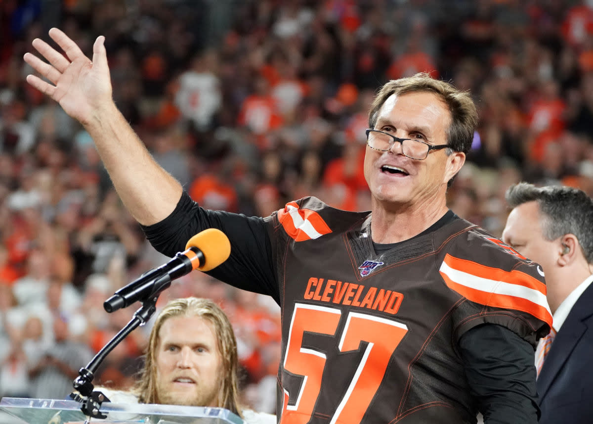 Former Browns linebacker Clay Matthews Jr. (57) speaks as he is inducted into the Browns Ring of Honor at halftime of a 2019 game against the Rams. His son and Rams linebacker Clay Matthews III can be seen in the background.